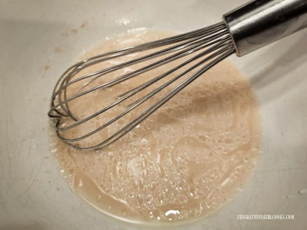 Oil, sugar, salt and water are whisked into the yeast mixture.