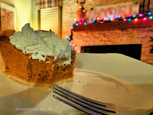 Classic Pumpkin Pie - The Grateful Girl Cooks! Partially eaten piece of pumpkin pie, with Christmas lights in the background.