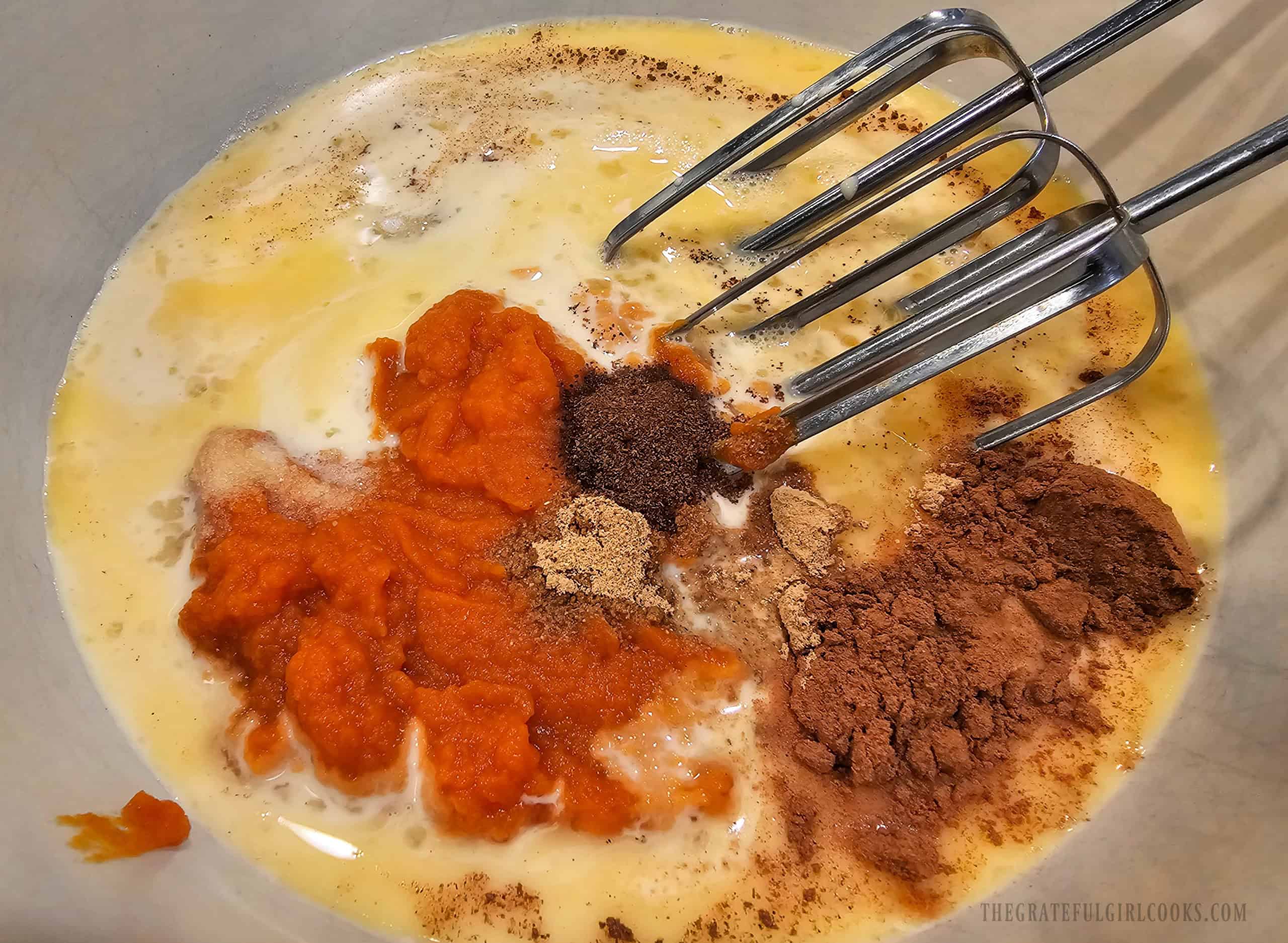 Classic Pumpkin Pie - The Grateful Girl Cooks! Pumpkin puree, sugar, egg mixture, spices and evaporated milk are beaten in a large bowl.