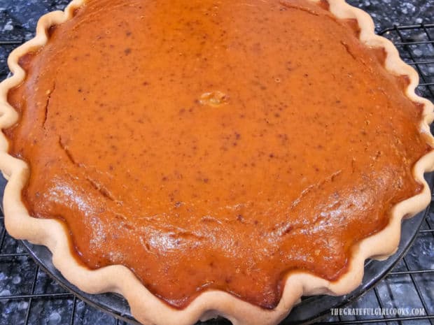 Classic Pumpkin Pie - The Grateful Girl Cooks! One classic pumpkin pie cooling on a wire rack after baking.