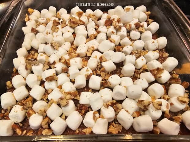 Miniature marshmallows and chopped pecans sprinkled on top of the casserole.