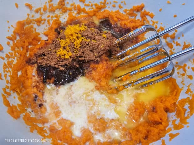 Spices, milk, egg, brown sugar, etc. are added to the mashed sweet potatoes.