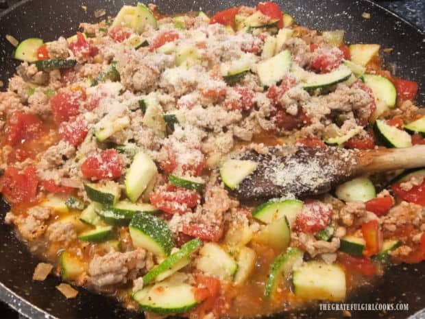 Finely grated Parmesan cheese is sprinkled on top of the turkey and veggie mixture.