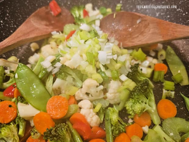 Chopped green onions are added to the stir-fried vegetables for the last minute of cooking.