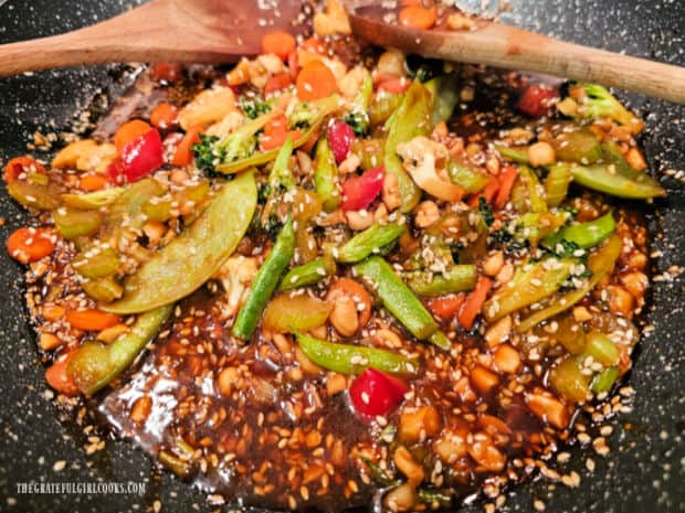 The veggies cook in the Asian-inspired sauce.