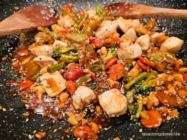 Veggies, sauce and chicken pieces are stirred until fully combined.