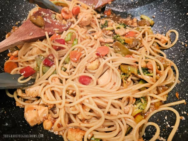 Hot drained pasta is added to the skillet of veggies, chicken and sauce and combined.
