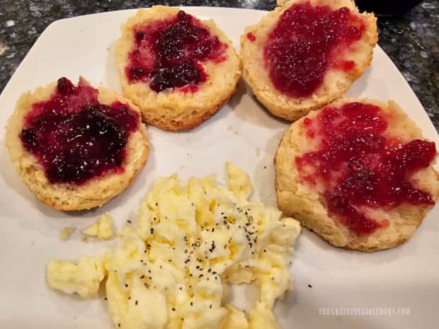 Buttery Bisquick Biscuits, split open and covered with butter and jam.