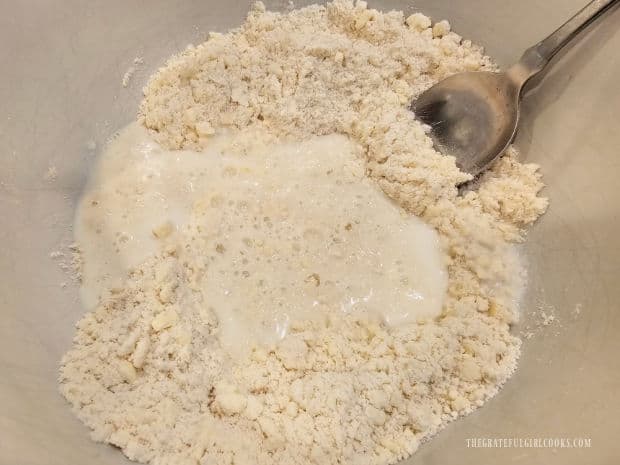 Milk is stirred into the flour and butter mixture until combined.