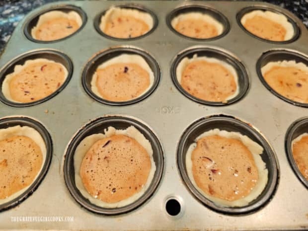 Each pastry shell is filled with the cranberry pecan filling and then baked.