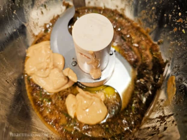 Dijon mustard is added to the herb and oil mixture and processed until combined.