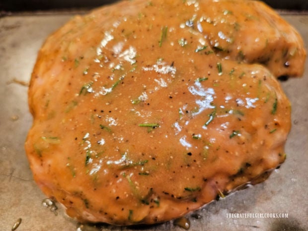 The pork butt (shoulder) is fully covered with sauce.