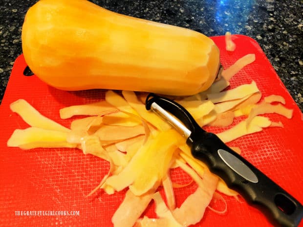 Oven-Roasted Butternut Squash - The Grateful Girl Cooks! A vegetable peeler is used to remove peeling from a butternut squash.