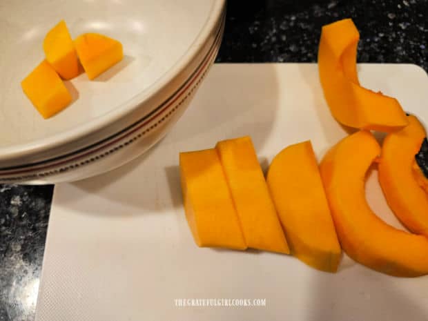 Oven-Roasted Butternut Squash - The Grateful Girl Cooks! Squash halves are cut into 1" slices, then into bite-sized cubes and put in a bowl.