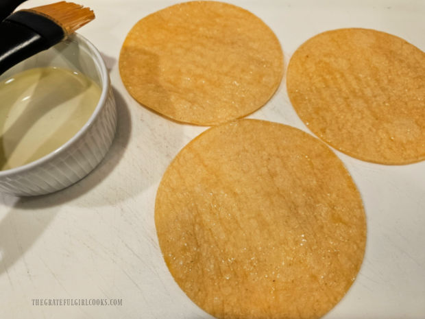 Lightly coated with oil and sprinkled with salt, the tortillas are ready to be sliced.