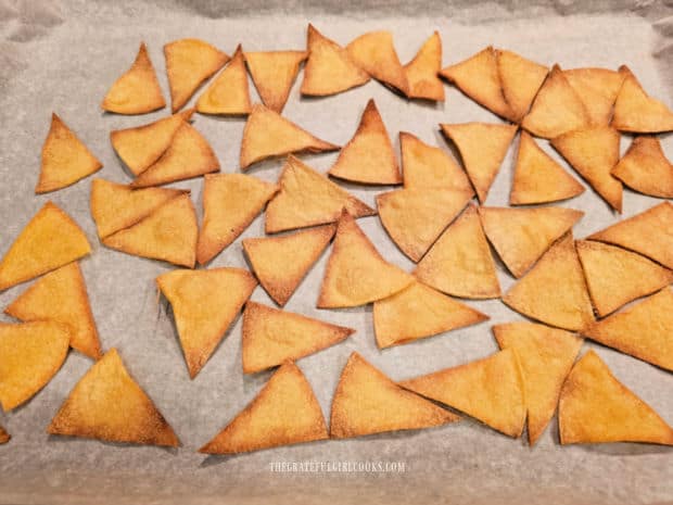 After baking, the homemade tortilla chips are lightly browned and very crispy.