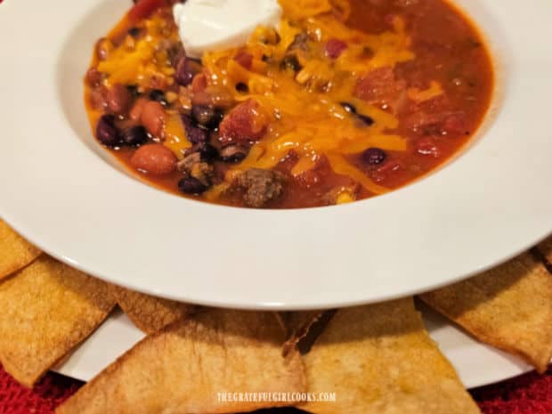 The baked homemade tortilla chips can be used for dipping up chili.