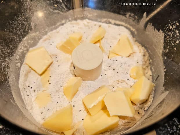 Chunks of cold butter are added, then processed until they become smaller.