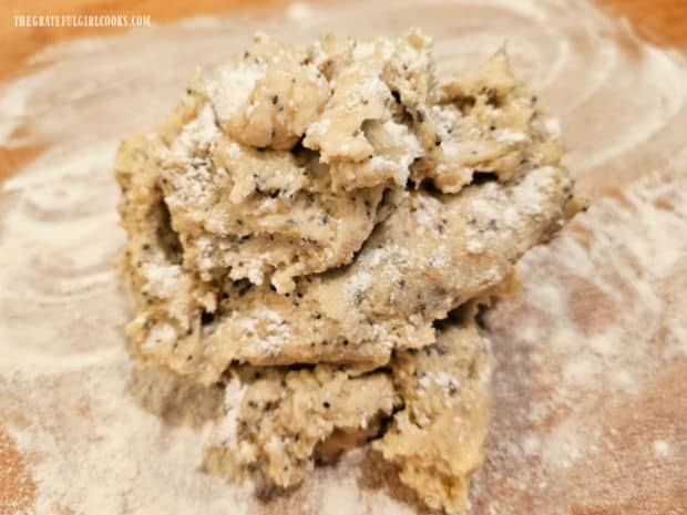 Dough is turned out onto a floured surface and then is dusted with flour.