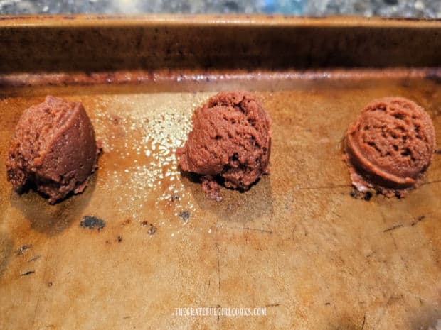 Peanut Butter and Nutella Cookies - The Grateful Girl Cooks! Rounded balls of cookie dough are placed onto a greased cookie sheet.