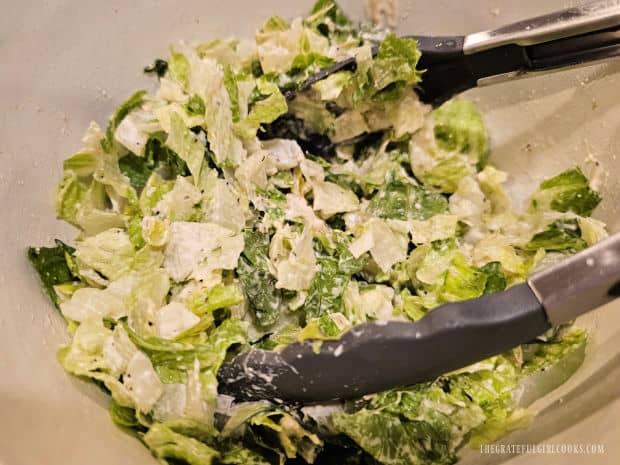 Creole Salmon Caesar Salad - The Grateful Girl Cooks! A Caesar salad dressing is added, and the salad is tossed to incorporate it.