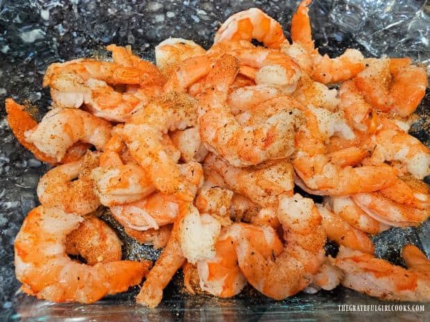 De-veined shrimp are seasoned with Cajun spice mix before cooking.
