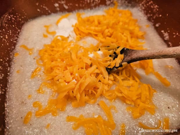 Sharp cheddar cheese and goat cheese are stirred into the hot grits.