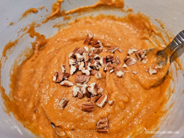 Chopped pecans are stirred into the pumpkin muffin batter.