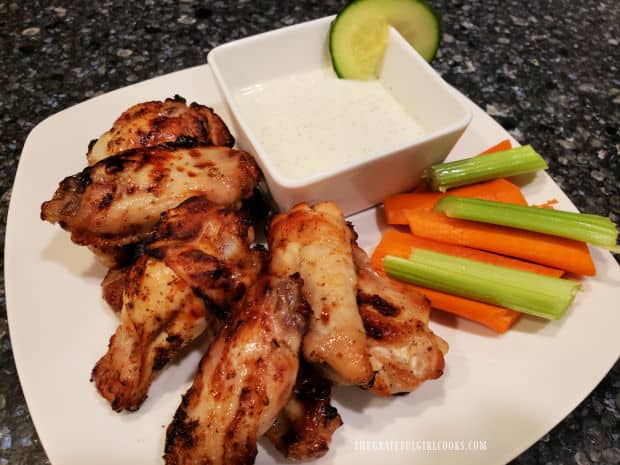 Greek-style chicken wings are cooked and then dipped into Greek Tzatziki Sauce.
