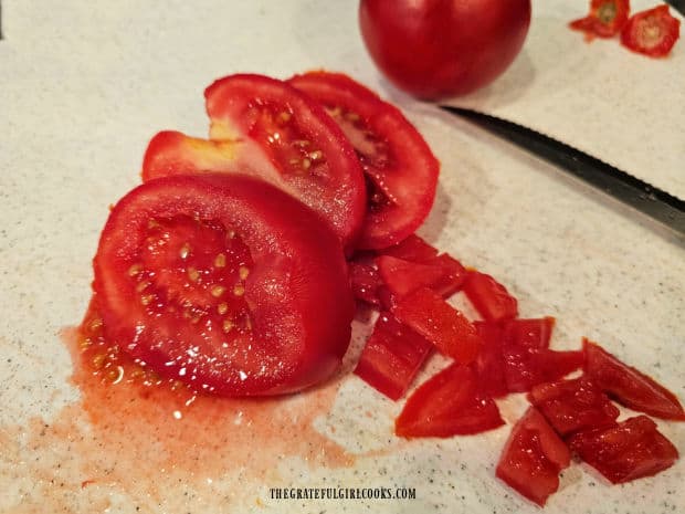 Fresh tomatoes are cut into small chunks for the salsa.