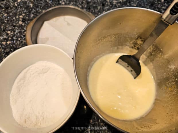 Prepared cake pan, plus bowls of dry ingredients and wet ingredients.