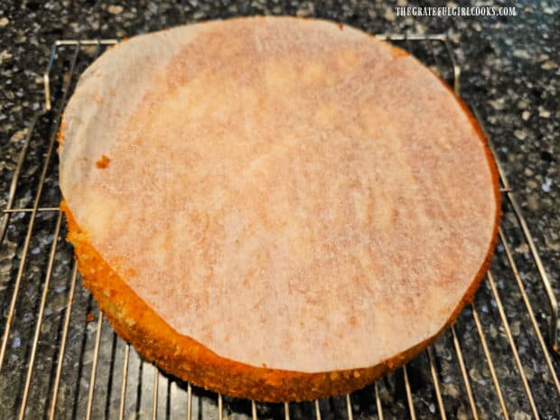 Inverted cake with parchment paper still on the top after baking.