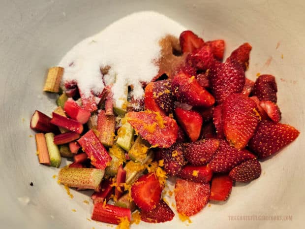 Ingredients for the strawberry rhubarb filling are mixed in a bowl.
