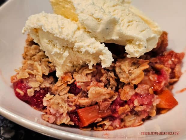 Topped with vanilla ice cream, the strawberry rhubarb crisp is served warm.