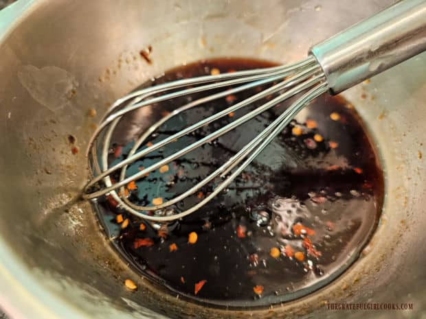 A whisk is used to incorporate the corn starch mixture into the sauce ingredients.
