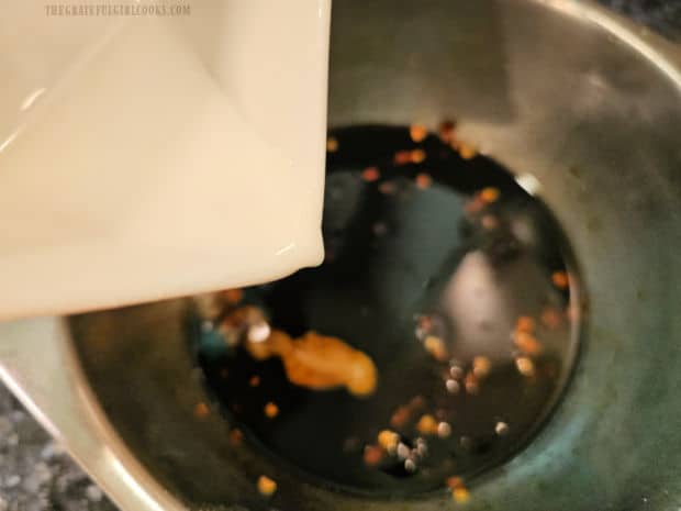 A slurry of cornstarch and water is added to the sauce for thickening.