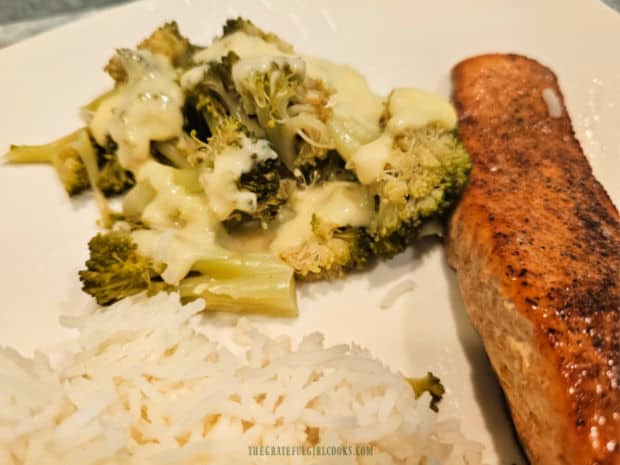 The broccoli and cheese sauce is served with salmon and white rice.