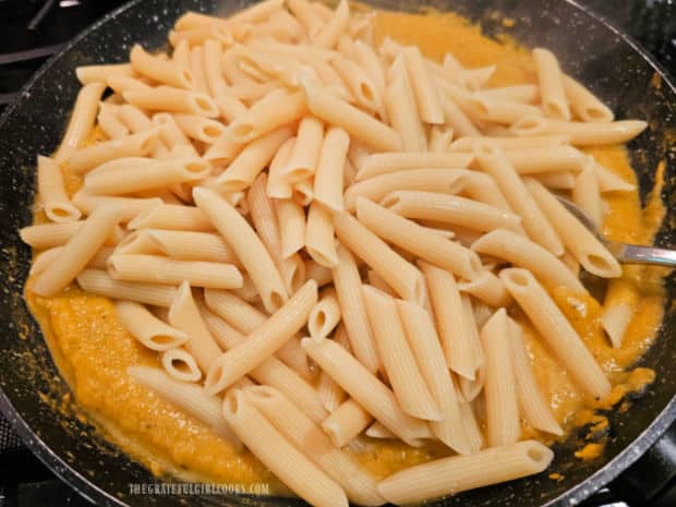 Cooked, drained penne pasta is combined with the butternut squash sauce.