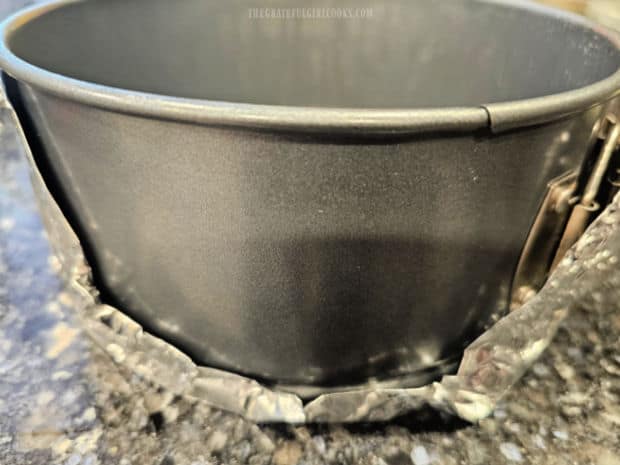 Springform pan is greased/floured and bottom of pan wrapped in foil.