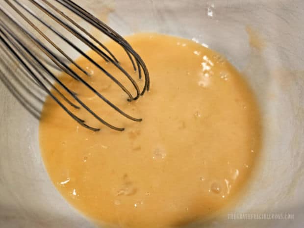 Eggs, oil and vanilla extract are whisked together until combined.