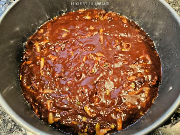 Batter for cake is spread in springform pan and ready for cooking.