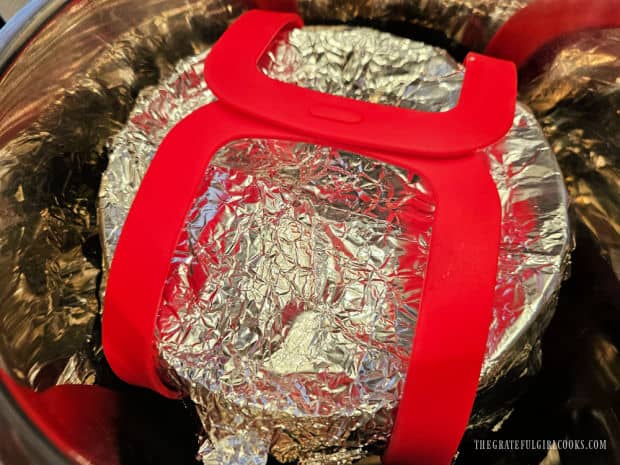 Covered pan is put into prepared Instant Pot for cooking.