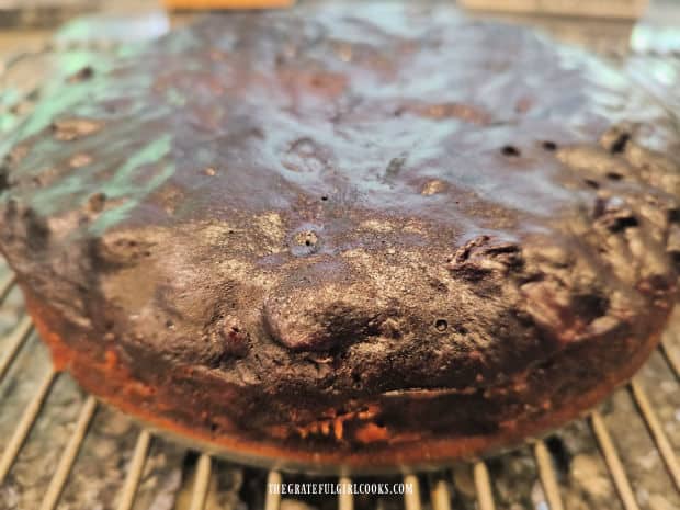 Cake is released from springform pan and placed on wire rack to finish cooling.