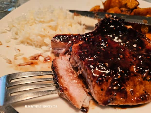 A slice of one of the raspberry balsamic pork chops reveals the juicy inside.
