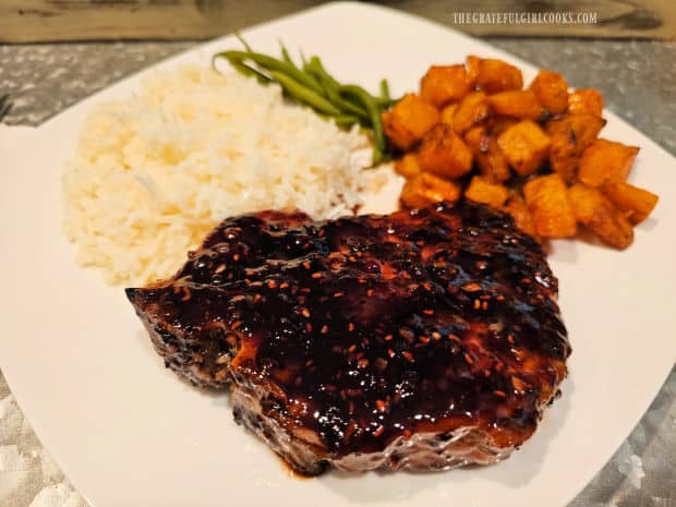 One of the raspberry balsamic pork chops is served with rice and veggies.
