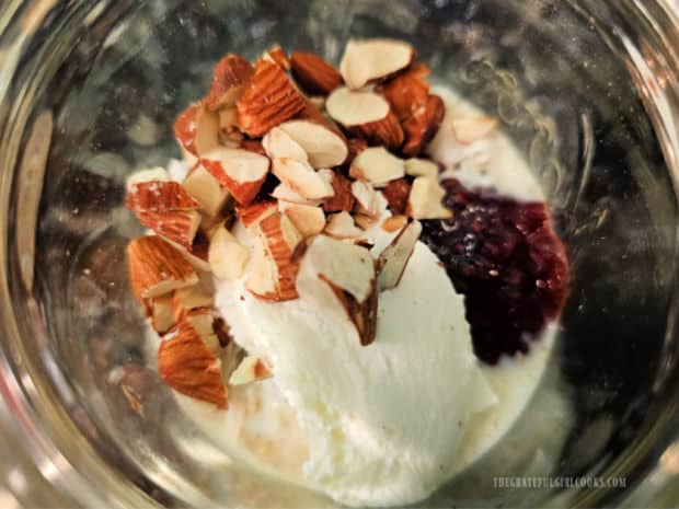 Raspberry Coconut Overnight Oats - The Grateful Girl Cooks! Greek yogurt and toasted, chopped almonds are added to the jar.