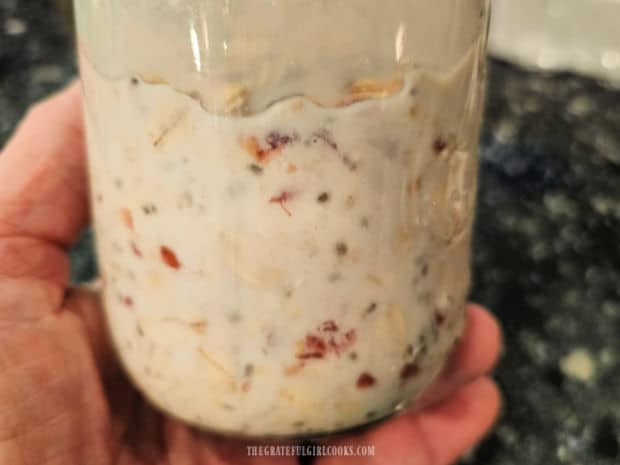 Raspberry Coconut Overnight Oats - The Grateful Girl Cooks! A side view of a jar of raspberry coconut overnight oats.