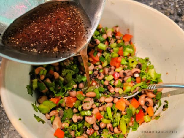 Texas Caviar - The Grateful Girl Cooks! Salad dressing is poured over the ingredients.