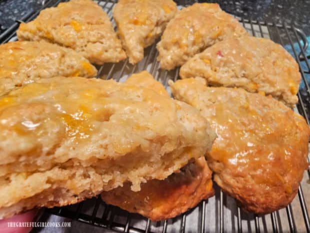 Glazed Peach Scones - The Grateful Girl Cooks! Holding up a ready to eat, glazed peach scone.